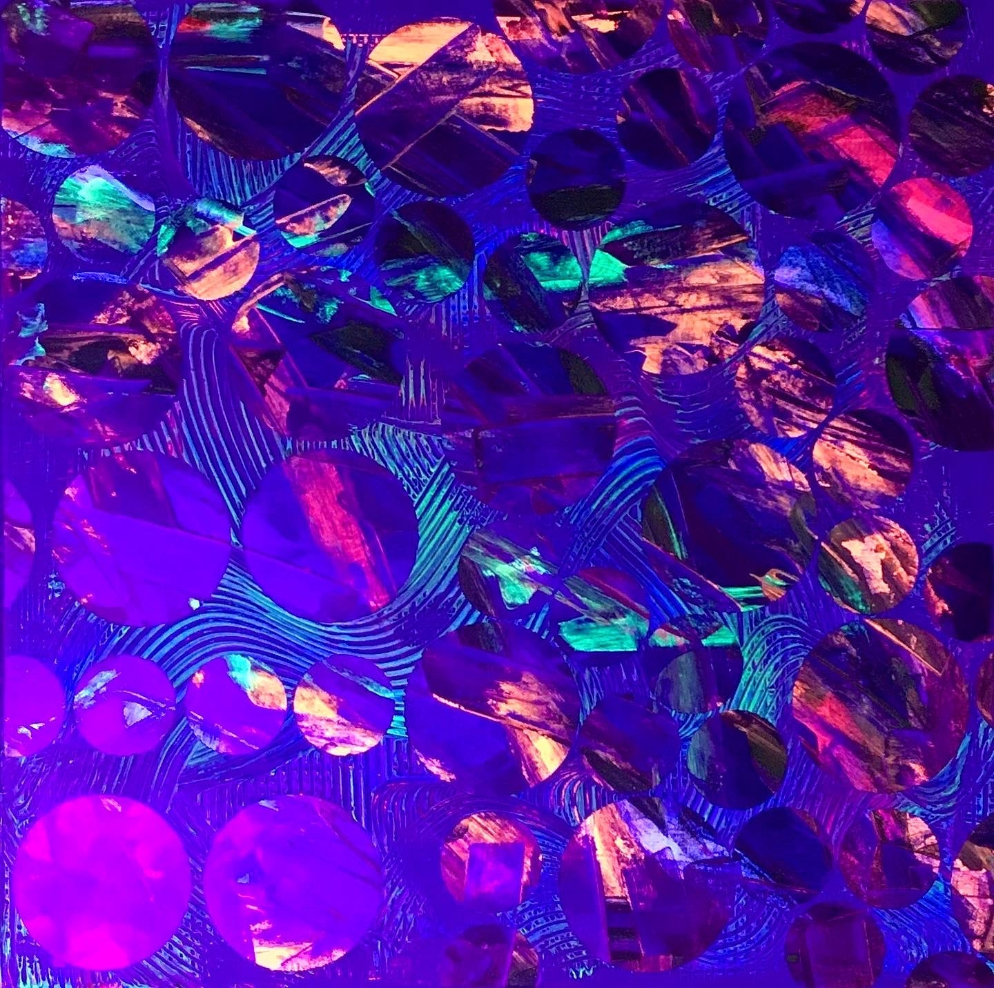 Metallic and fluorescent acrylics painting with colorful circles, under UV light
